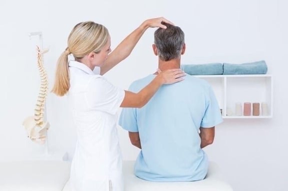 slip and fall chiropractor examining a patients neck. 